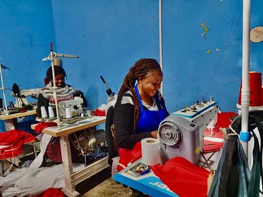 Women learning practical skills at sewing machines